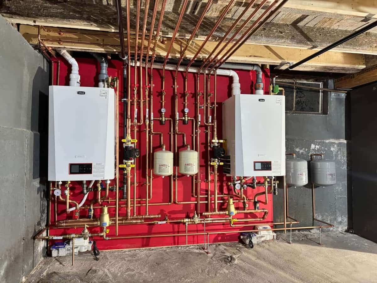 Twin Ideal high-efficiency boilers with new copper piping installed in a Lynnfield basement by Precision Plumbing Solutions