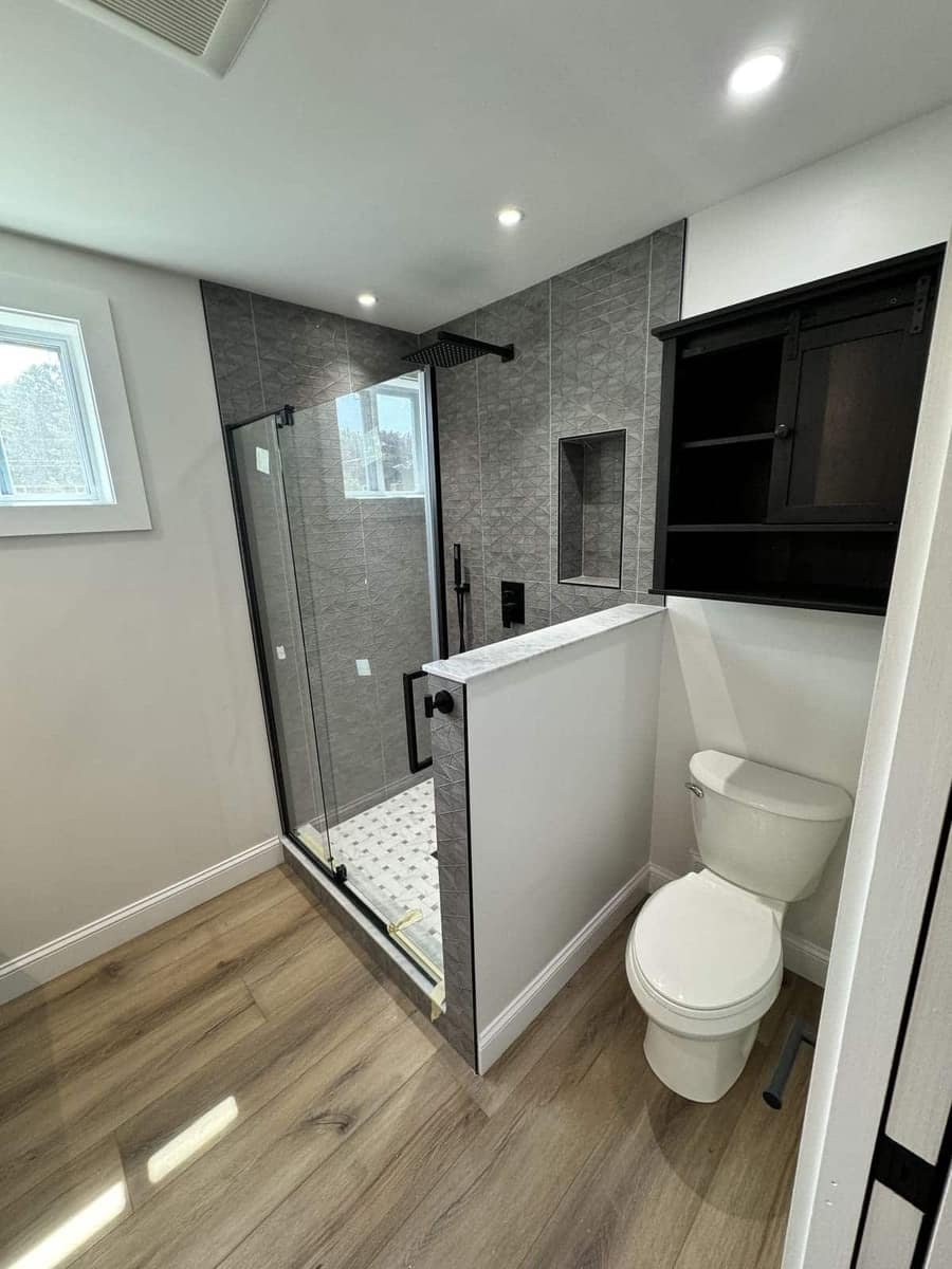New toilet and glass shower installed during a bathroom renovation by Precision Plumbing Solutions