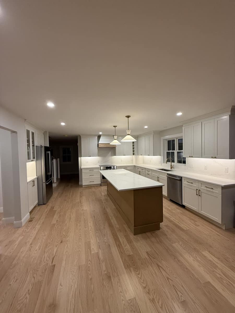 Kitchen island with sink and brass faucet installed during a remodel by Precision Plumbing Solutions