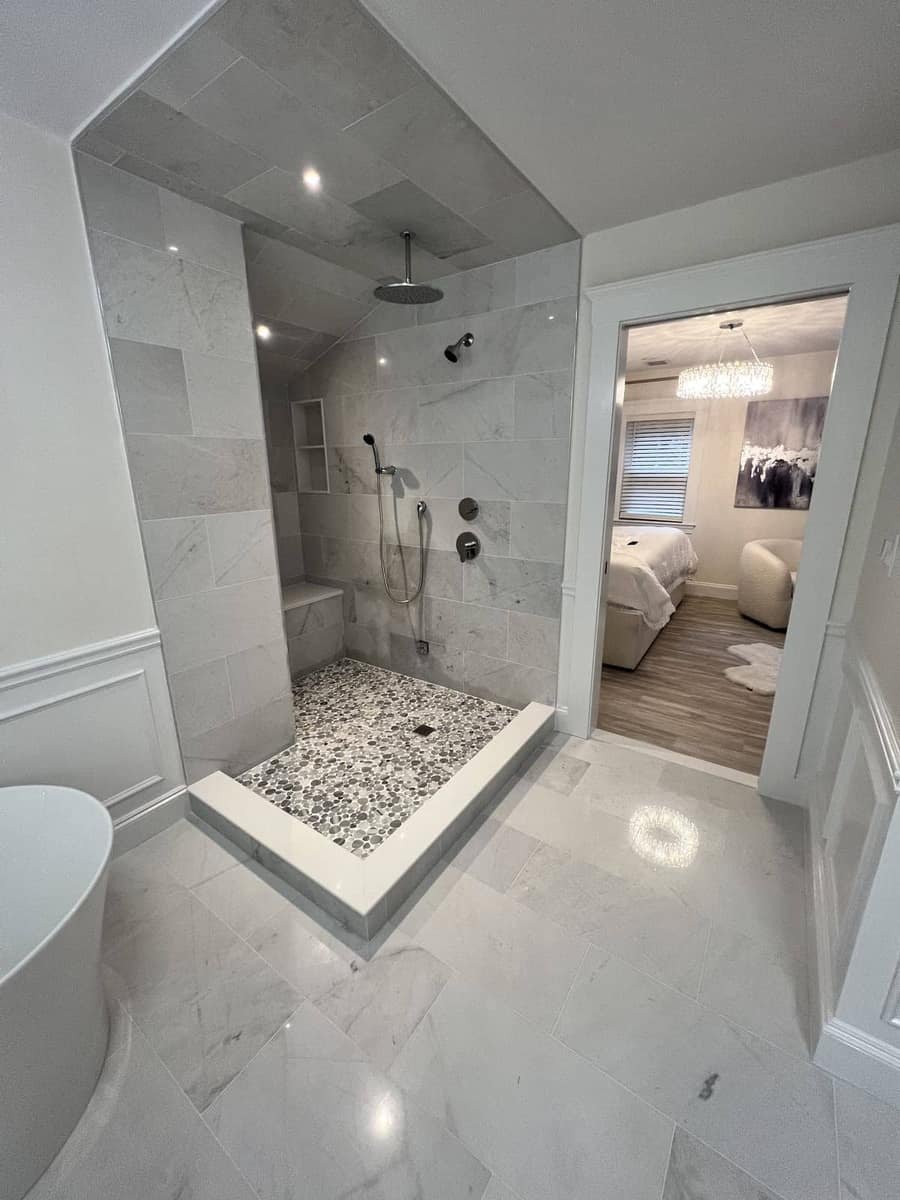 Marble walk-in shower with pebble floor — Precision Plumbing Solutions