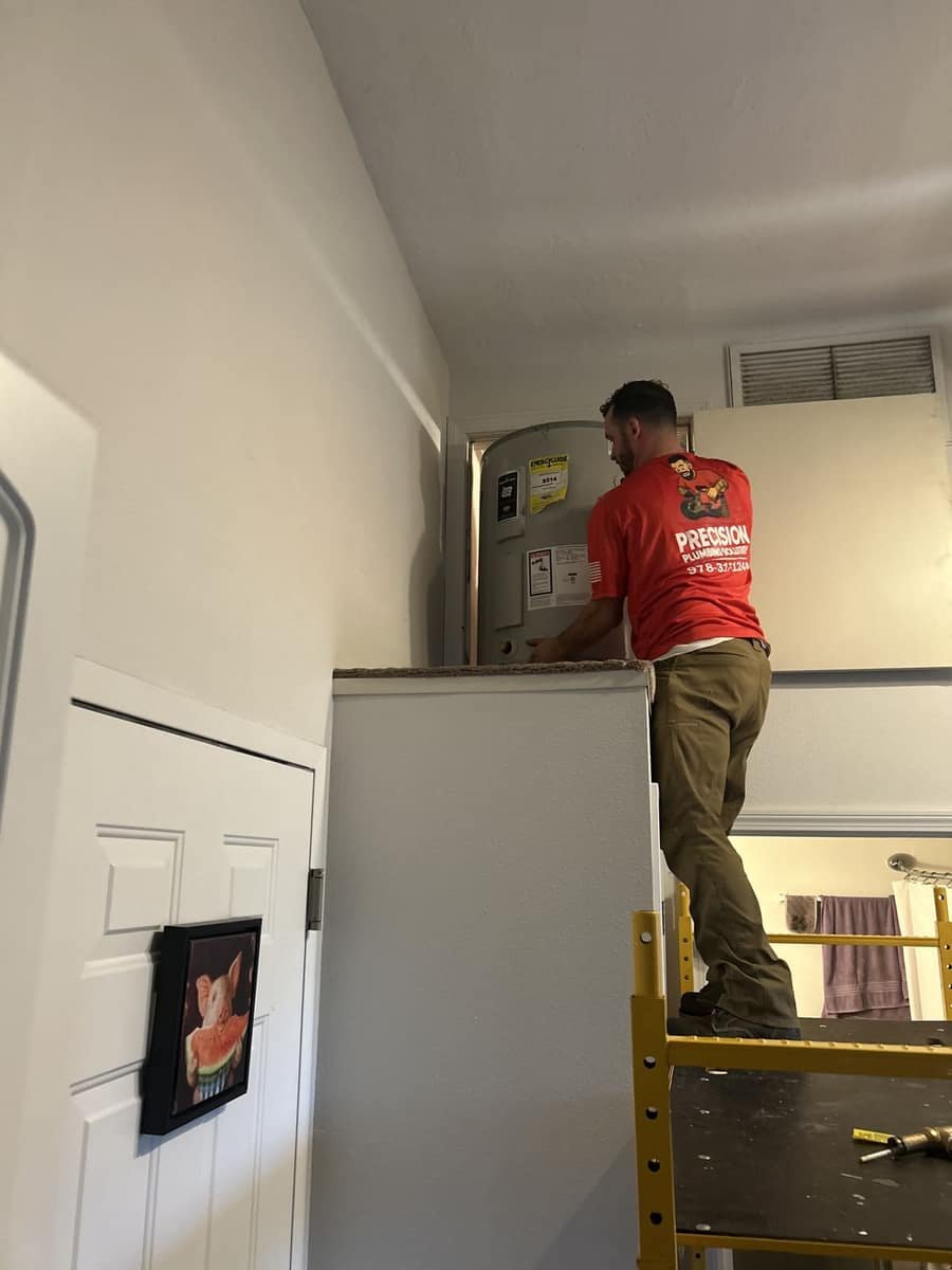 Precision Plumbing Solutions plumber working from a ladder on a job