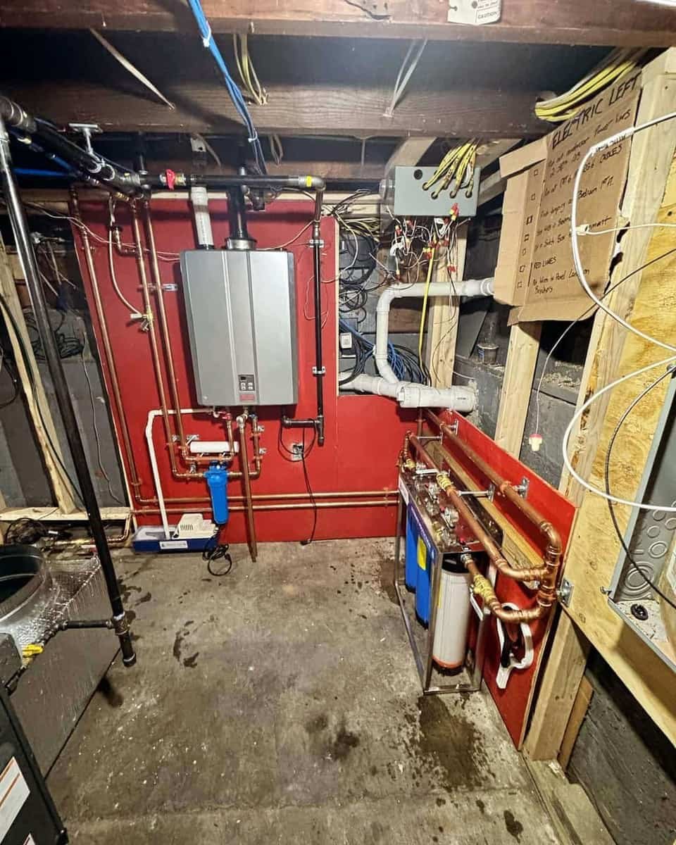 Water heater, filtration and supply lines serviced in a basement mechanical room by Precision Plumbing Solutions